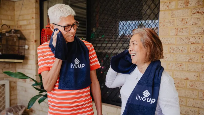 Two older people catch their breath after exercising.