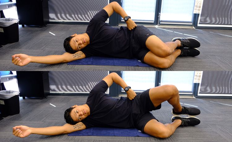 A man lying on floor doing the clam shell exercise.