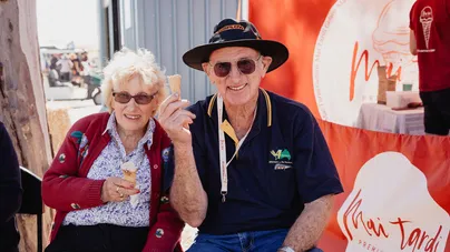 An older couple eating ice cream together.