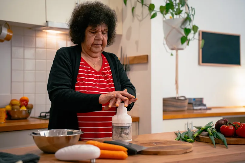 Image of a woman using a food wand in the kitchen.