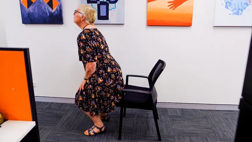 A woman getting up from her chair.
