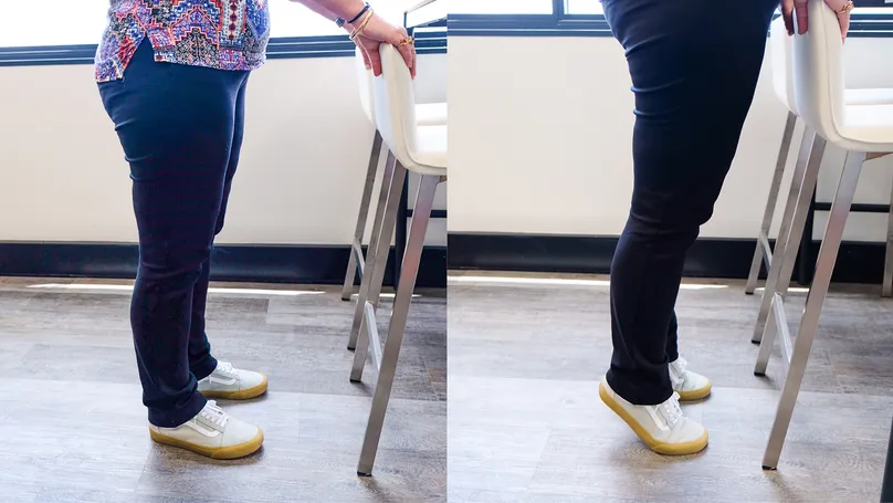 A woman doing the heel raise exercise.