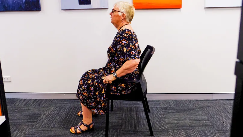 A woman sitting on a chair.