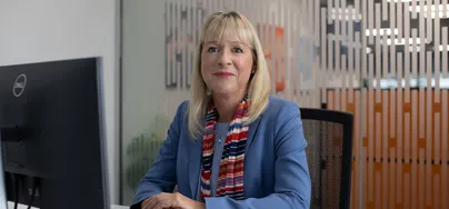 Image of Hilary O'Connell smiling in a bright office setting.