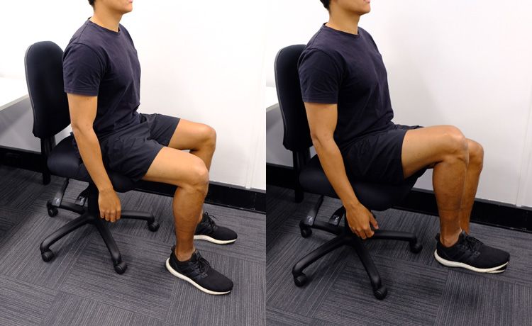 A man sitting in a chair doing the hip marching exercise.