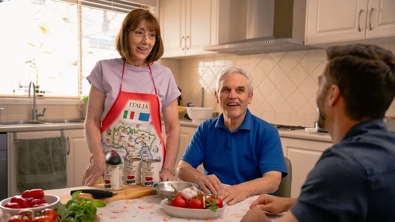 An Italian family at the table preparing food.