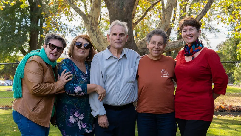 Older Italian community members smiling together.