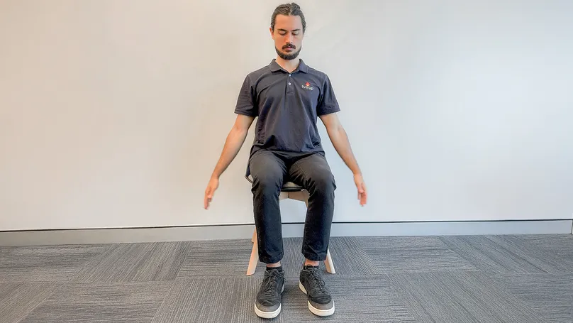 Image of man seated doing mountain pose in yoga