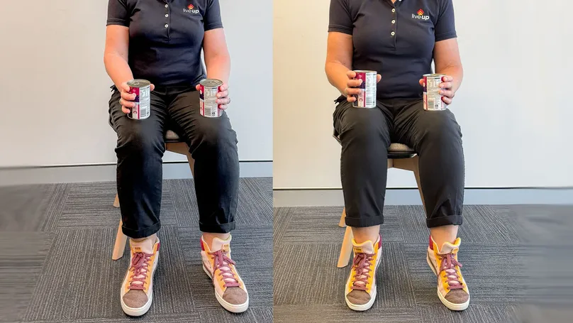 A woman doing seated heel raises with cans.