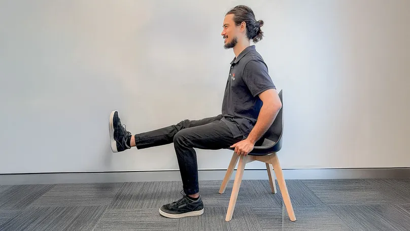 A man doing a seated leg extension.