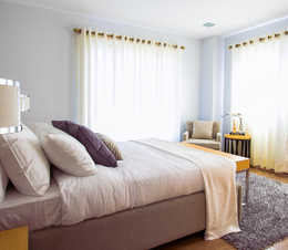 A bed on a tall bed frame.