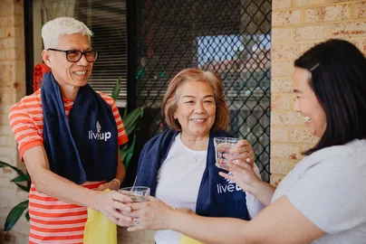 Image of an older couple taking glasses of water after exercise.