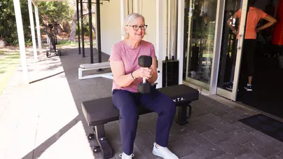 older woman in gym with weights