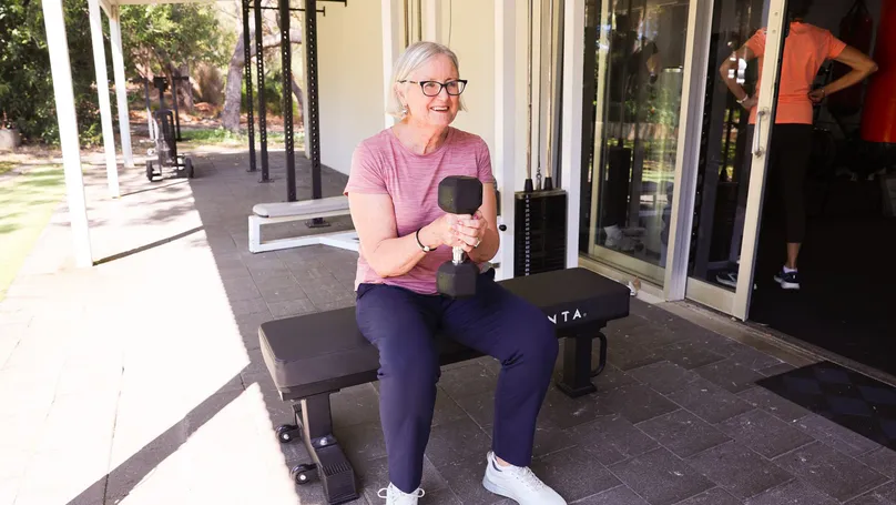 older woman in gym with weights