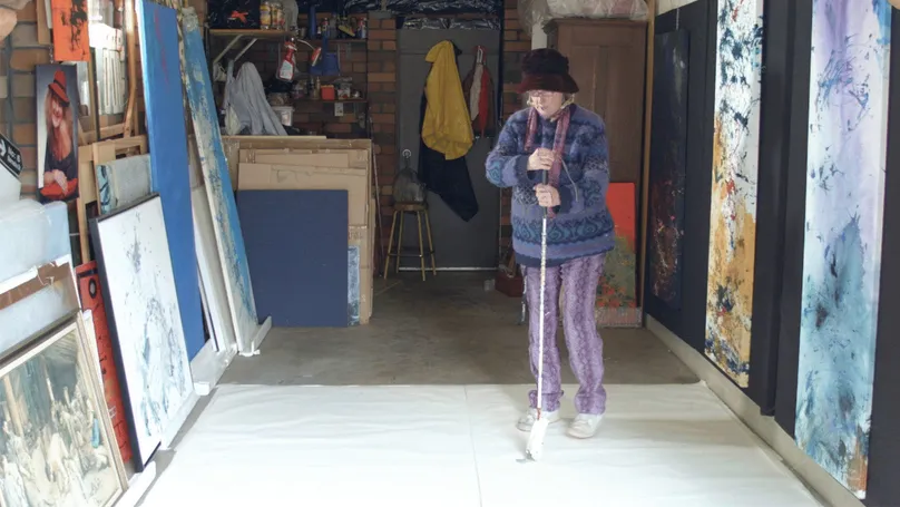 Woman painting using white cane