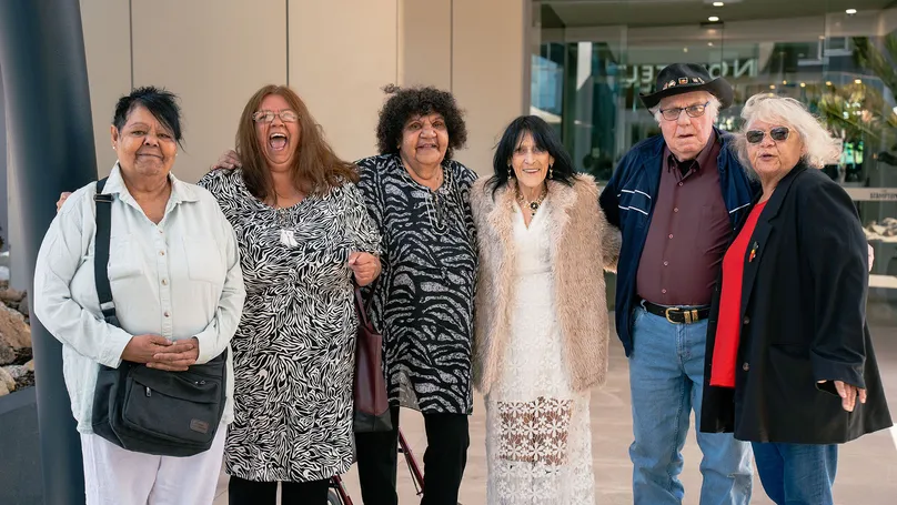 The elder working group standing together and smiling at the camera.