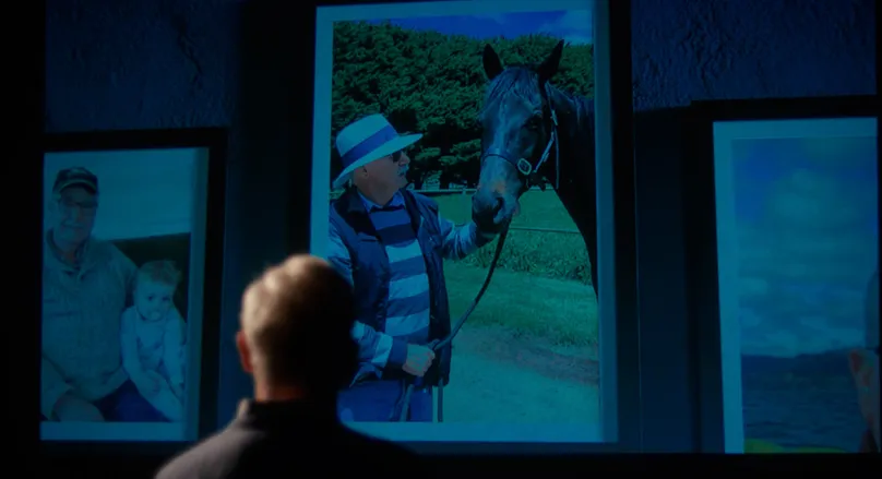 Terry looking at projector of his family.