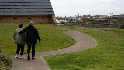 Image of two women walking down a path together.