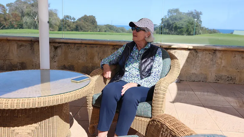 Woman sitting outdoors in armchair