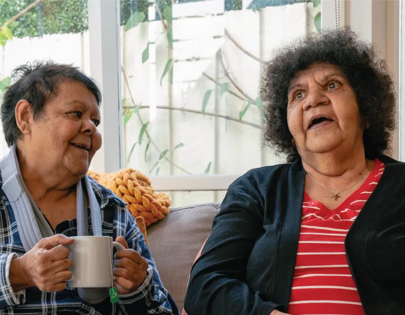 Image of older first nations women having tea on the couch.