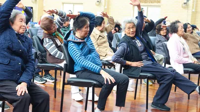 chair yoga class overhead press