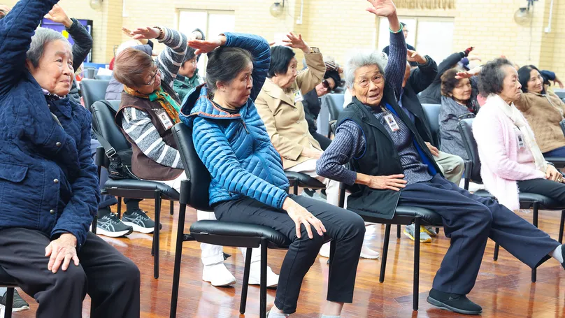 chair yoga class overhead press
