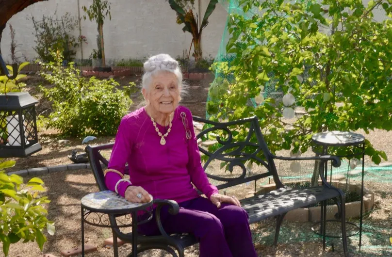 Image of Dr Gladys sitting in her garden