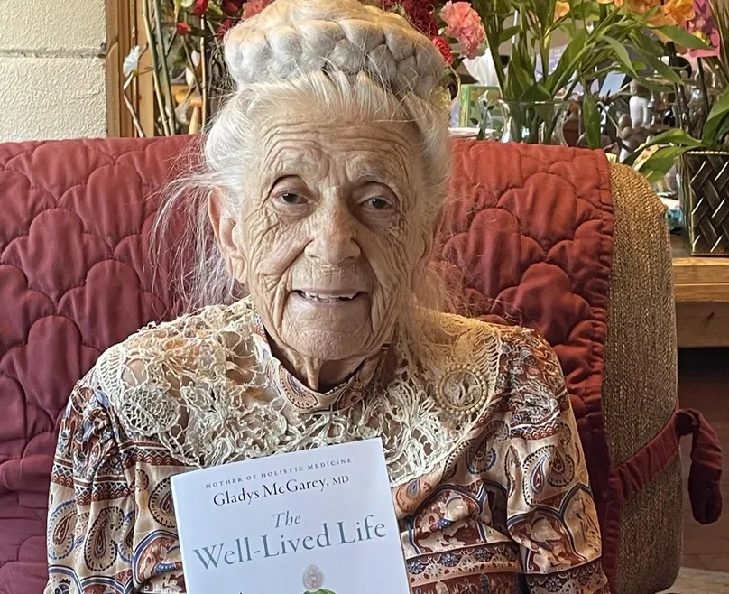 Dr Gladys holding her biography