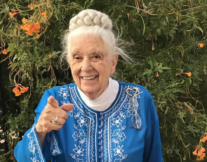 Image of dr Gladys pointing and smiling