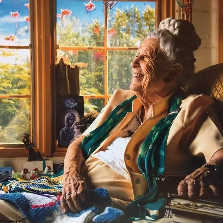 Image of dr Gladys smiling while looking out the window