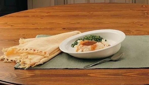 A scoop plate with food on it.