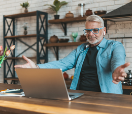 A man is happy while using his laptop.