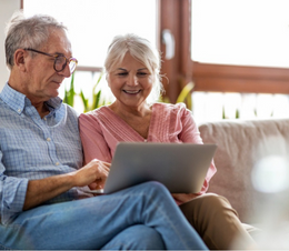 Older couple using the laptop together.
