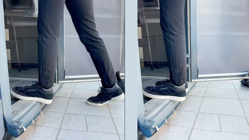 A man stepping up onto a doorstep.