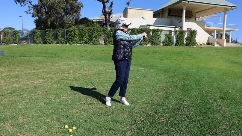Woman playing golf.